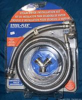 Front view of the Steel-Flex branded Universal Steam Dryer Installation Kit including two flexible hoses and a brass Y-splitter fitting in original packaging.