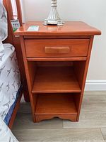 Front view of Vilas maple nightstand showing drawer and lower shelves
