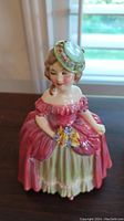 Front view of Royal Doulton Dainty May figurine, showing detailed dress and bonnet.