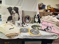 Wide view of Border Collie collectibles including pillows, plates, mugs, towels, and plush toy