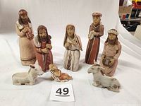 Full set of clay Peruvian figurines including Holy Family, 3 Kings, and 2 donkeys with earth tones visible for condition and completeness review.