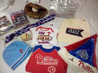 Photo showing collection including jerseys, gloves, baseballs, books, lanyards, hat, bag, and card pages.