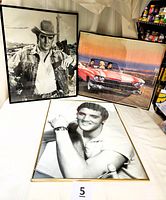 Three framed posters including young Elvis Presley portrait in gold frame, cowboy Elvis in black frame, and colorful Rt. 66 scene with Elvis, Marilyn Monroe and James Dean in red Cadillac.