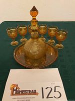 View of the set including decanter, six cordial glasses, and serving tray with lot number card