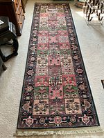 Full top-down view of the Karastan Chahar Mahal runner showing the full length and design with fringed edge at one end, placed on light carpeted floor.
