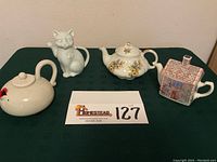 Lot of four teapots including Fitz and Floyd Lip Service, Takahashi cat, Woods and Sons ironstone, Sadler cottage house