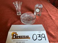 Photo showing Waterford Marquis crystal clock, vase, and wine holder arranged on a table