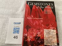 Book 'Gemstones of the World' by Walter Schumann front cover showing detailed red gemstone imagery and edition information.