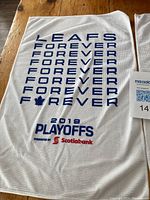 Toronto Maple Leafs 2019 Playoffs rally towel with 'LEAFS FOREVER' text, maple leaf logo, and Scotiabank sponsorship logo on white mesh fabric.