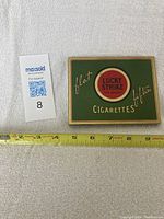 Top view of the closed Lucky Strike tin box showing design and branding.