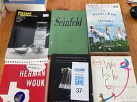 Photo showing six paperback books including Instant Yiddish, Seinfeld Memory Book, The Sunday List of Dreams, What Looks Like Crazy on an Ordinary Day, The Caine Mutiny, and a book with 'Love' in the title.