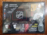 NHL 2010 Poker Chip Set original packaging showing poker chips, playing cards, and booklet with Stanley Cup image