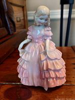 Front view of the Royal Doulton Rose figurine showing detailed card and facial features