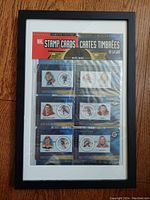Front view of framed NHL stamp cards sealed in original packaging showing six players with stamps.