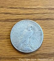 Reverse side of the 1922 U.S. silver dollar coin showing eagle perched on rock with rays behind and inscriptions.
