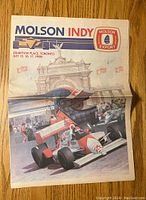 Front cover of the 1988 Molson Indy newspaper showing Indy race cars and Exhibition Place landmark in Toronto with event dates July 15-17, 1988.