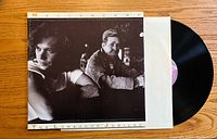 Front cover of the vinyl record album showing John Mellencamp and another man in black and white.
