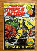 Front cover of Marvel Triple Action #4 comic showing The Thing fighting Dr. Doom with Silver Surfer flying, colorful and clear image.