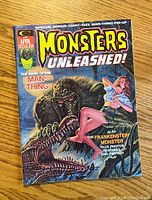 Front cover of Monsters Unleashed comic magazine showing Man-Thing and a woman in distress in vibrant, colorful comic art style.