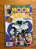 Front cover of Moon Knight #1 comic with colorful illustration of Moon Knight and supporting characters, dated November 1980 with 50 cents cover price.