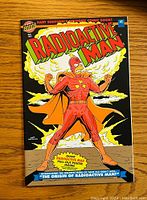 Front cover of Radioactive Man #1 vintage comic book showing superhero in red costume with mushroom cloud background and colorful title.