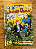 Front cover shows colorful vintage comic art with Superman and Jimmy Olsen with money piles, issue number 108, January, priced 12 cents.