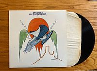 Photo of the front of the album cover with iconic artwork showing a bird and sun in southwestern desert motif.