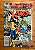 Front cover of The Uncanny X-Men #153 comic book showing colorful artwork of X-Men characters and a bike giveaway ad.