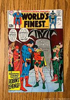 Front cover photo of World's Finest Comics #184 featuring Superman, Batman, Robin, Green Lantern and The Flash around a tombstone commemorating Batman