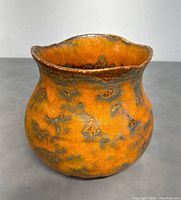 Front and side views showing the rounded shape, wavy flared rim, and mottled orange-gray-brown glaze of the 1970s Royal Haeger mid-century modern urn.