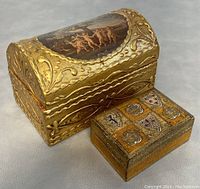 Two vintage Florentine jewelry boxes showing exterior gold gilded wood surfaces and decorative motifs