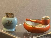 Porcelain lighter and ashtray on shelf, showing size and general condition