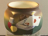 Side view showing hand-painted playing cards (ace of hearts) with poker chips on a gradient gold to green background.