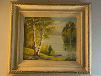Full view of the oil painting showing birch trees, lake, and mountains in the decorative gold and silver frame.