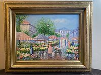 Framed oil on canvas painting of flower market scene showing entire artwork and frame