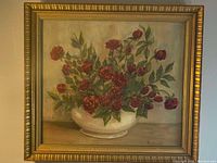 Photo of entire framed painting showing red roses still life with gold frame