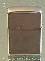 Front view of the vintage Zippo lighter showing the engraved Niagara Falls scene on the smooth metal surface.