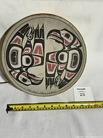 Full top view of the Haida indigenous art drum with a measuring tape showing an approximate diameter of 15 inches.