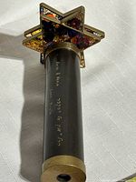 Bottom view of the handle showing the gold-tone base and inscription in Hebrew and English with personalized message to Alex & Kevin.