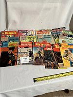 Lot of 18 vintage comic books displayed in a row including Zorro, Mary Poppins, Classic Illustrated Junior titles