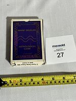 Box of Marie Delclos Astrological Game cards showing navy blue and gold box with the game title and year 1990.