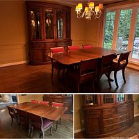 Wide view of dining table with six upholstered chairs and matching hutch cabinet in dining room.