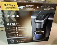 Box of Keurig K-Elite single serve coffee maker showing model and features.