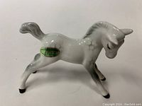 Side view of the glossy grey foal horse figurine with Beswick label visible on the body.