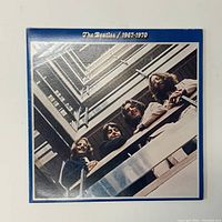 Front cover of The Beatles 1967-1970 vinyl LP showing the band members in a stairwell and album title at the top.