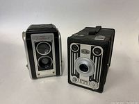 Photo showing two vintage box cameras: Kodak Duaflex II and Bilora Stahl Box camera side by side.