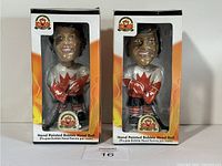 Two hand-painted bobblehead dolls shown in boxes with 1972 Team Canada logos and player details.