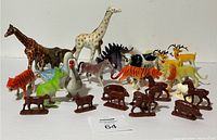 Wide view of all animal toys displayed together on a white surface, showing size and variety.
