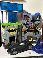 Wide view of Batcave playset with Batman vehicles, showing multiple sections and details.