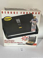 Front view of the George Foreman Jumbo Size Grill box showing the branding, product image and key features including large cooking surface and health benefits.
